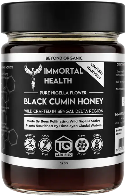 Jar of Immortal Health Black Cumin Honey with a black label reading 'Pure Nigella Flower Black Cumin Honey' and icons for organic, GMO-free, raw, gluten-free (325 g).